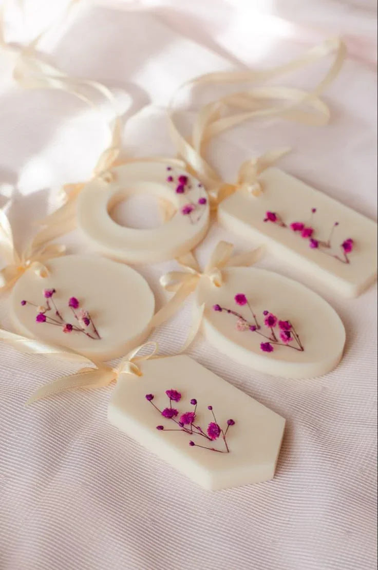 Luxury soy wax aroma sachets with dried pink flowers and ribbons on soft fabric, Fiorance Luxe