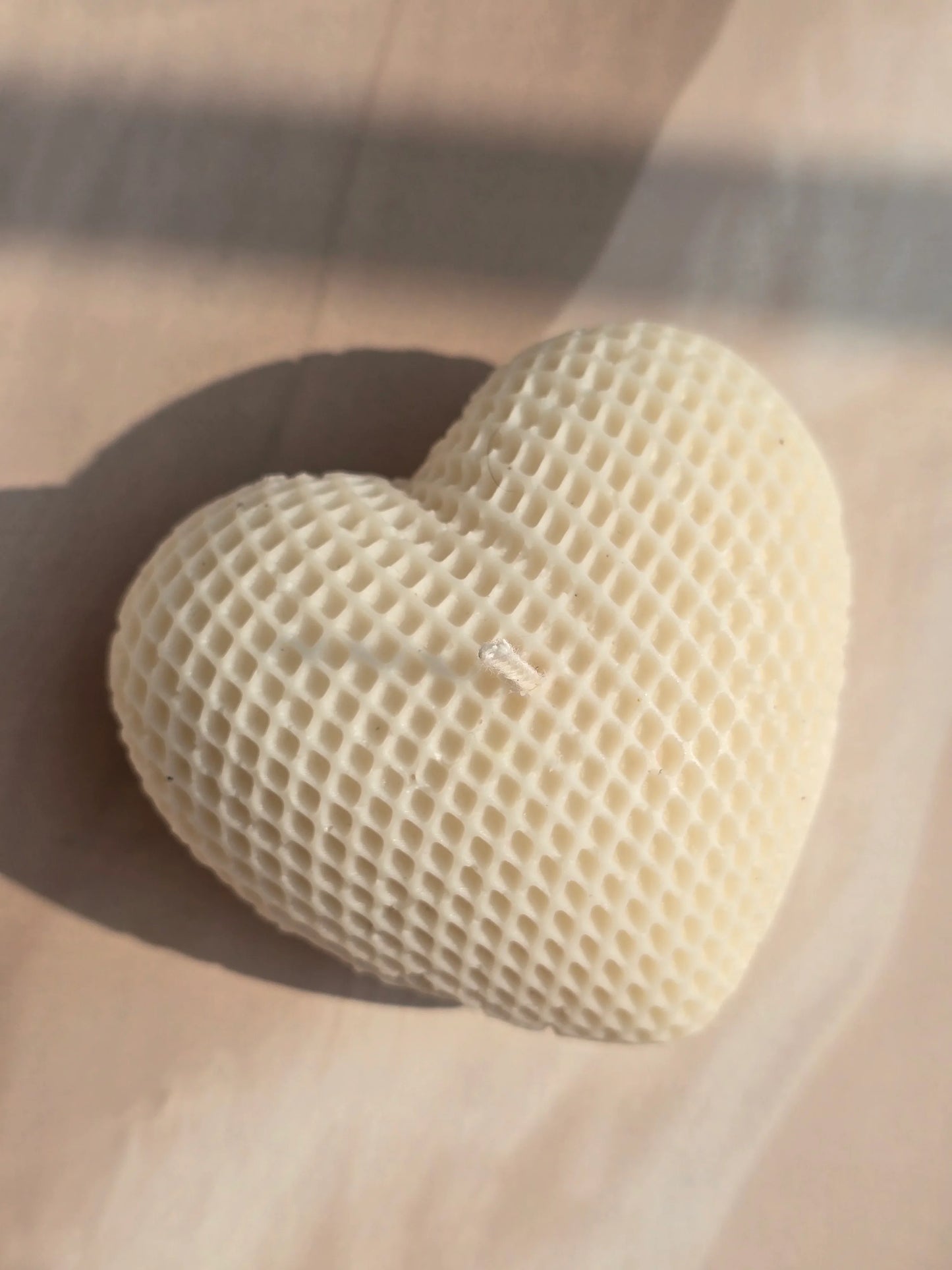 Heart-shaped honeycomb candy on a wooden surface
