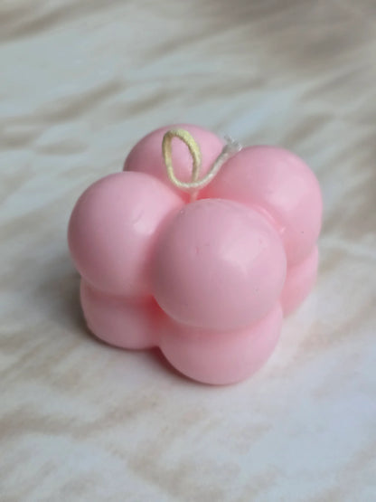 Pink bubble soy wax candle by Fiorance Luxe on a marble surface, luxury floral decor