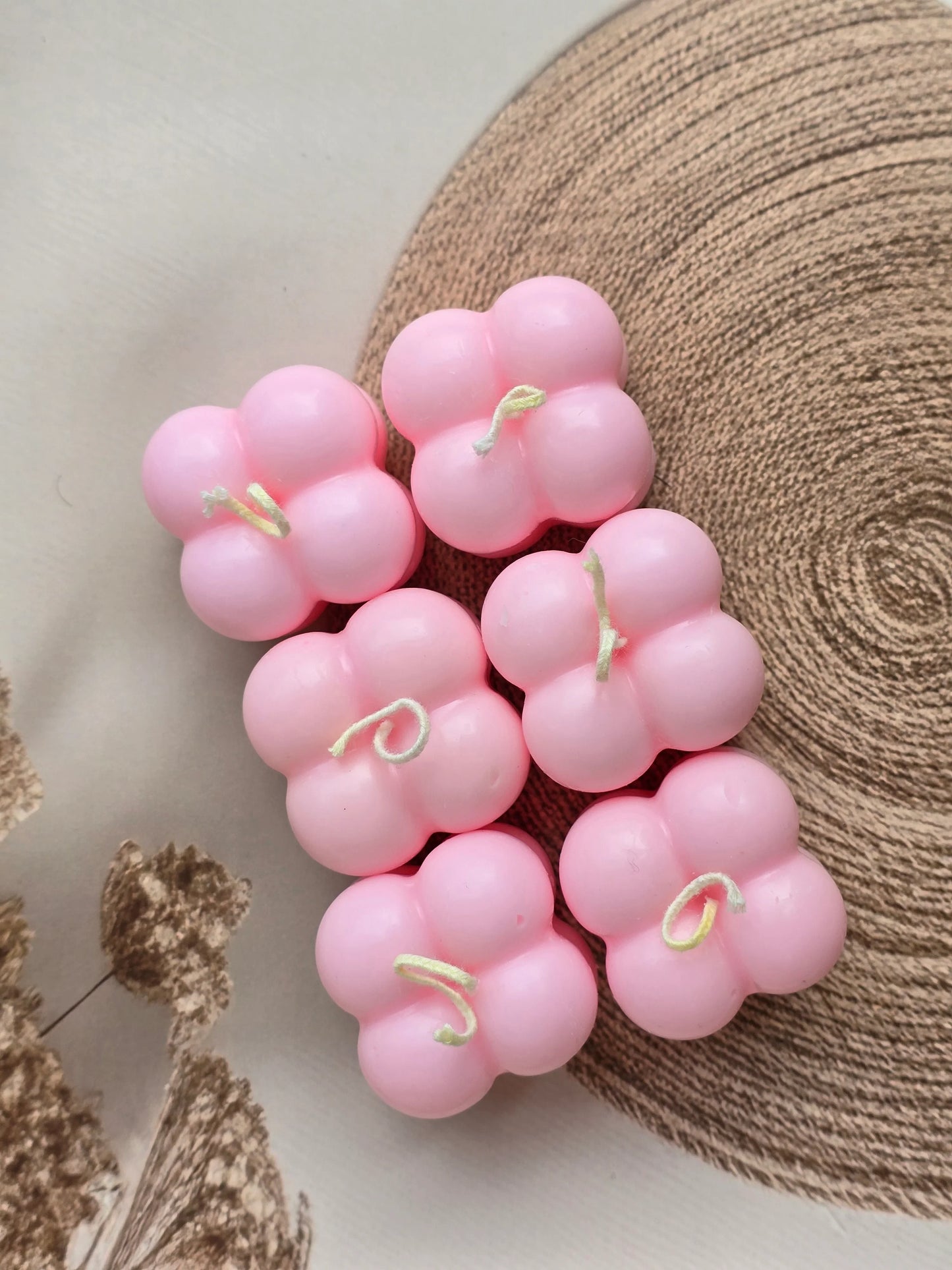 Six pink floral soy wax candles from Fiorance Luxe arranged on a neutral background