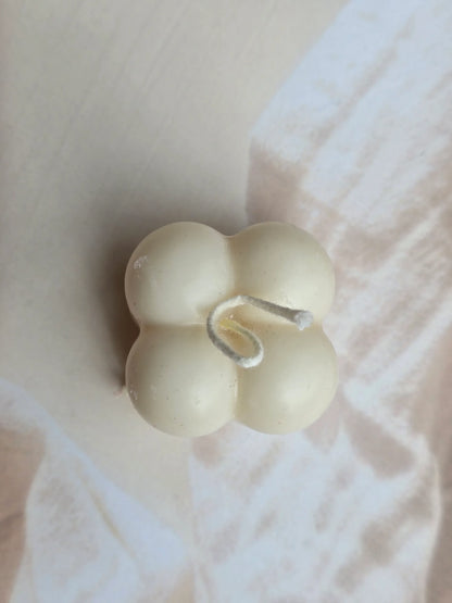 Fiorance Luxe floral-shaped soy wax candle on a soft beige background