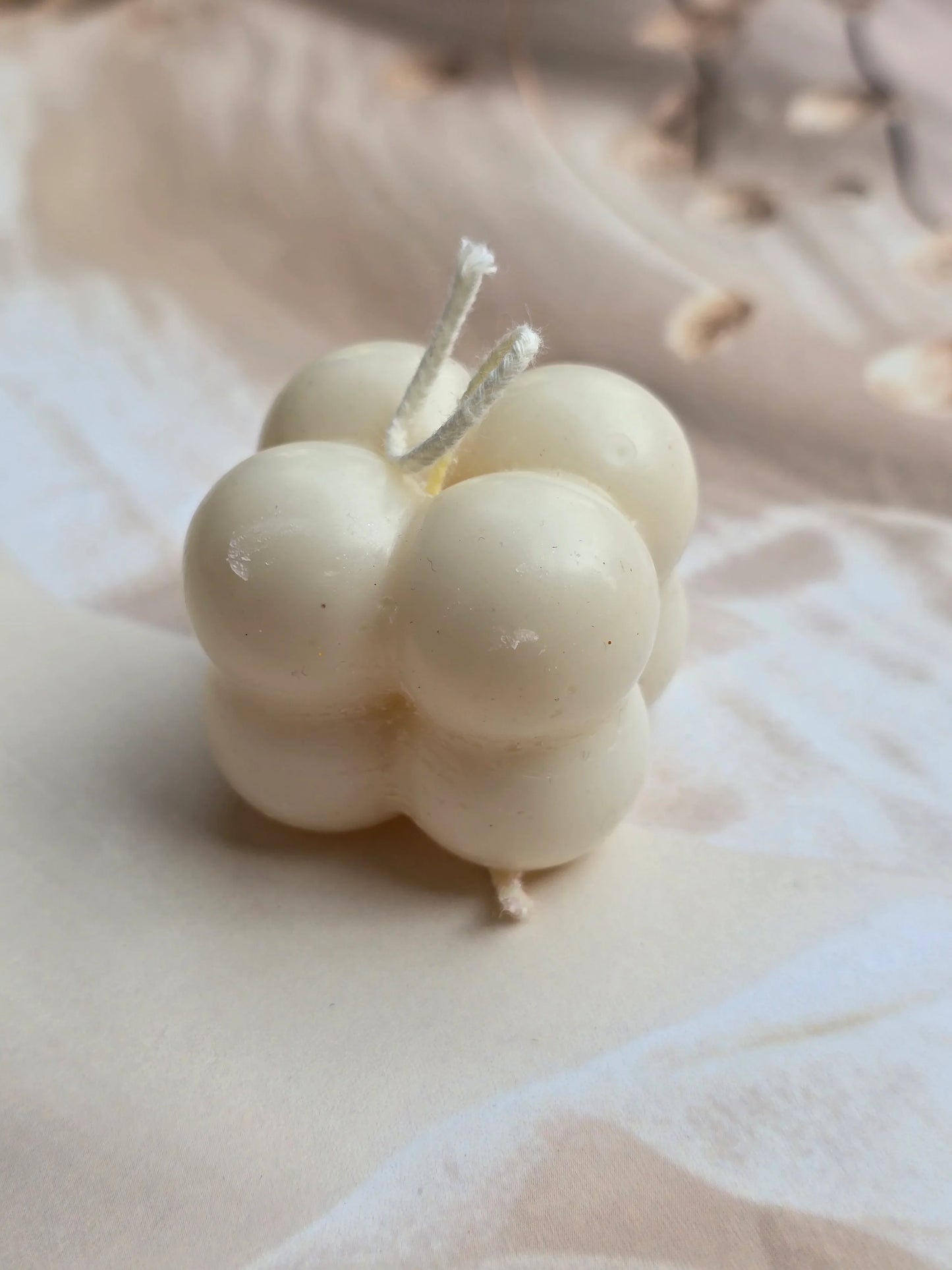 Fiorance Luxe handcrafted soy wax bubble candle on a soft beige background