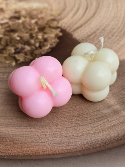 Pink and white floral soy wax candles from Fiorance Luxe on a wooden tray