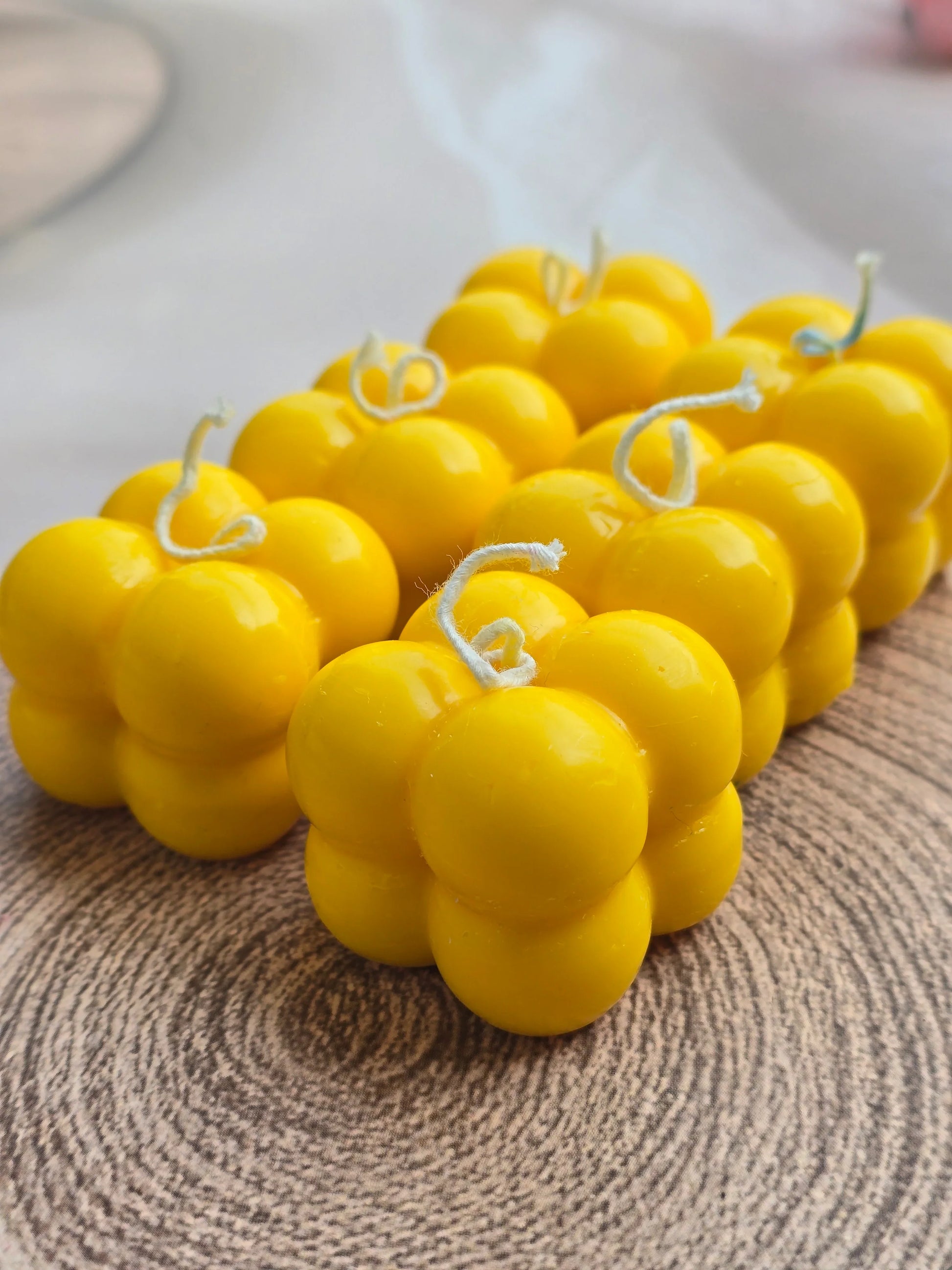 Yellow bubble soy wax candles by Fiorance Luxe on wood surface, luxury scented candle decor