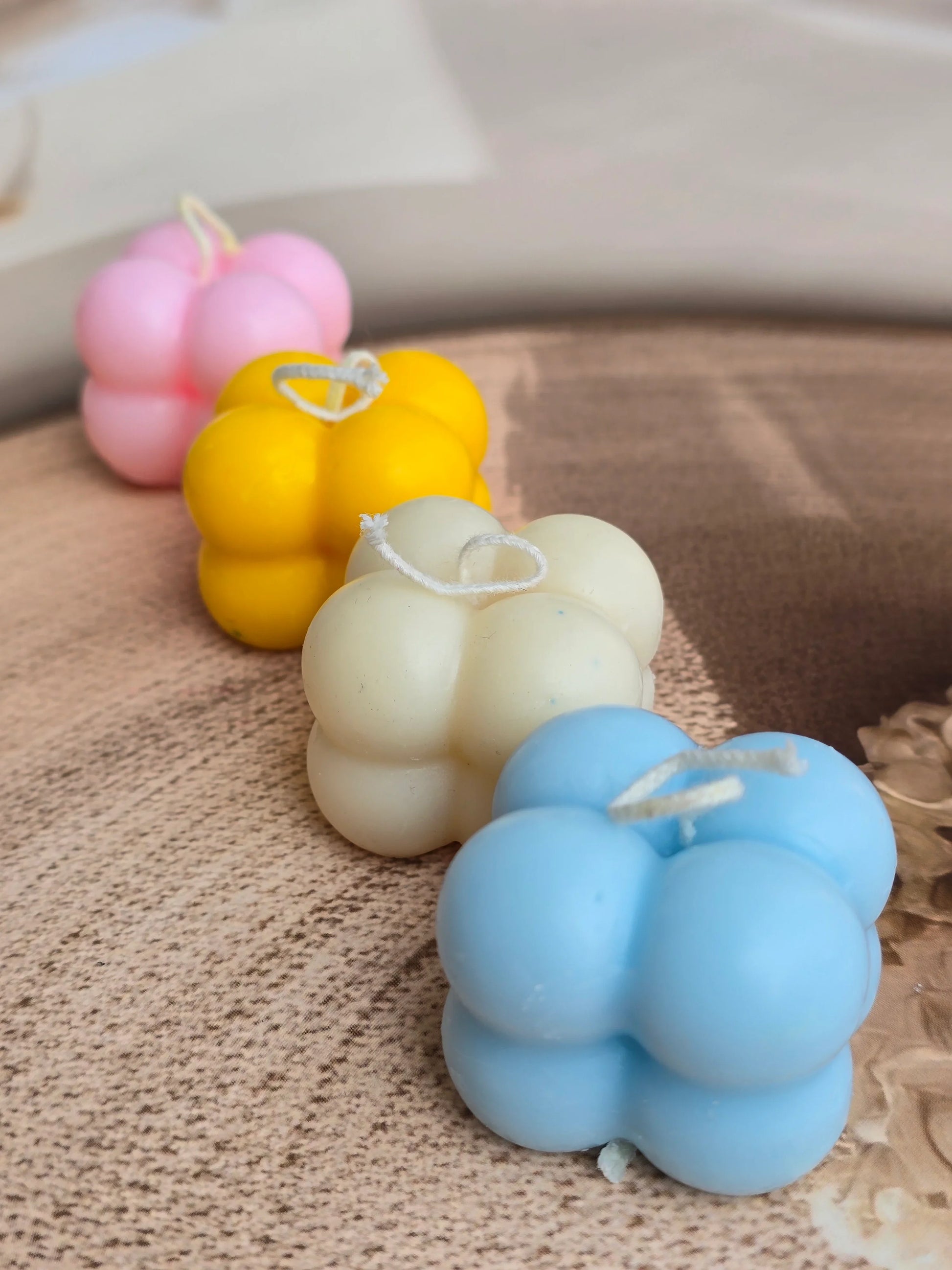 Colorful bubble-shaped soy wax candles on a wooden tray, Fiorance Luxe premium decor.