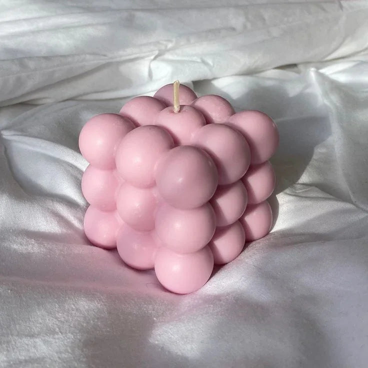 Pink bubble soy wax candle on white fabric, Fiorance Luxe luxury home decor.
