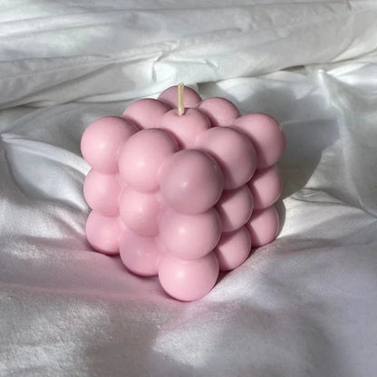 Pink bubble soy wax candle on white fabric, Fiorance Luxe luxury home decor.