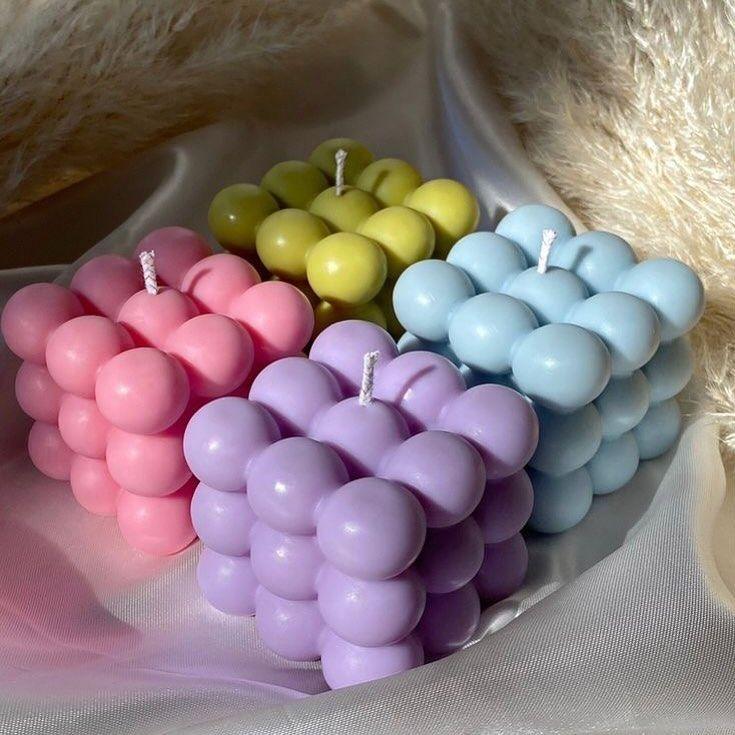 Colorful bubble soy wax candles by Fiorance Luxe on soft fabric, luxury scented decor