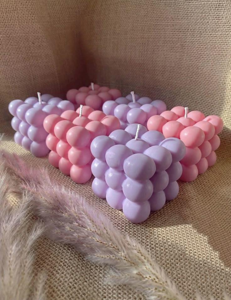 Pastel pink and lavender bubble soy wax candles by Fiorance Luxe on burlap fabric