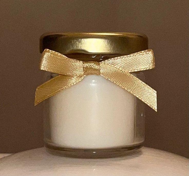 Luxury soy wax candle in glass jar with gold lid and ribbon by Fiorance Luxe