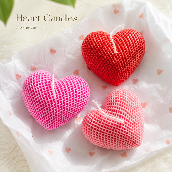 heart shaped candles placed on a white surface