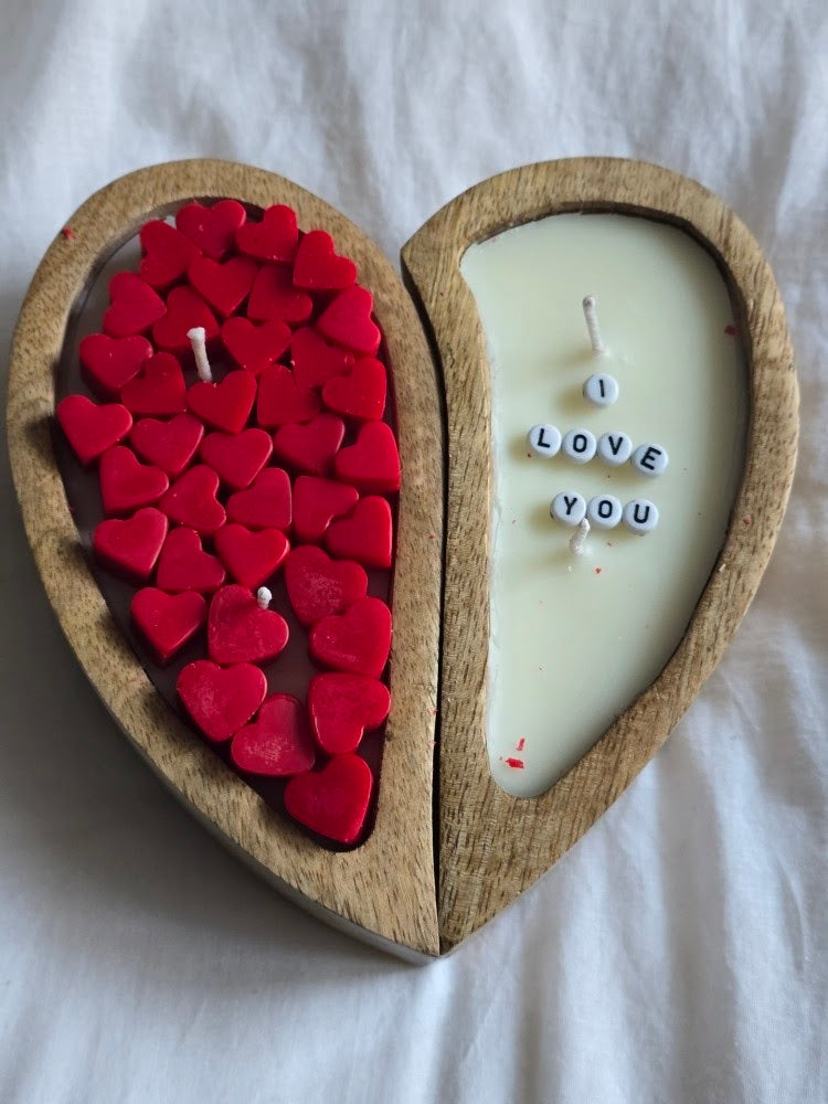 Heart-shaped wooden candle with red heart-shaped candles and a white candle with 'I LOVE YOU' letters.