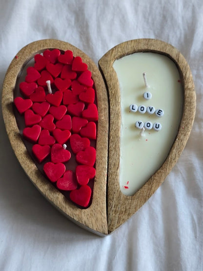 Heart-shaped wooden candle with red heart-shaped candles and a white candle with 'I LOVE YOU' letters.