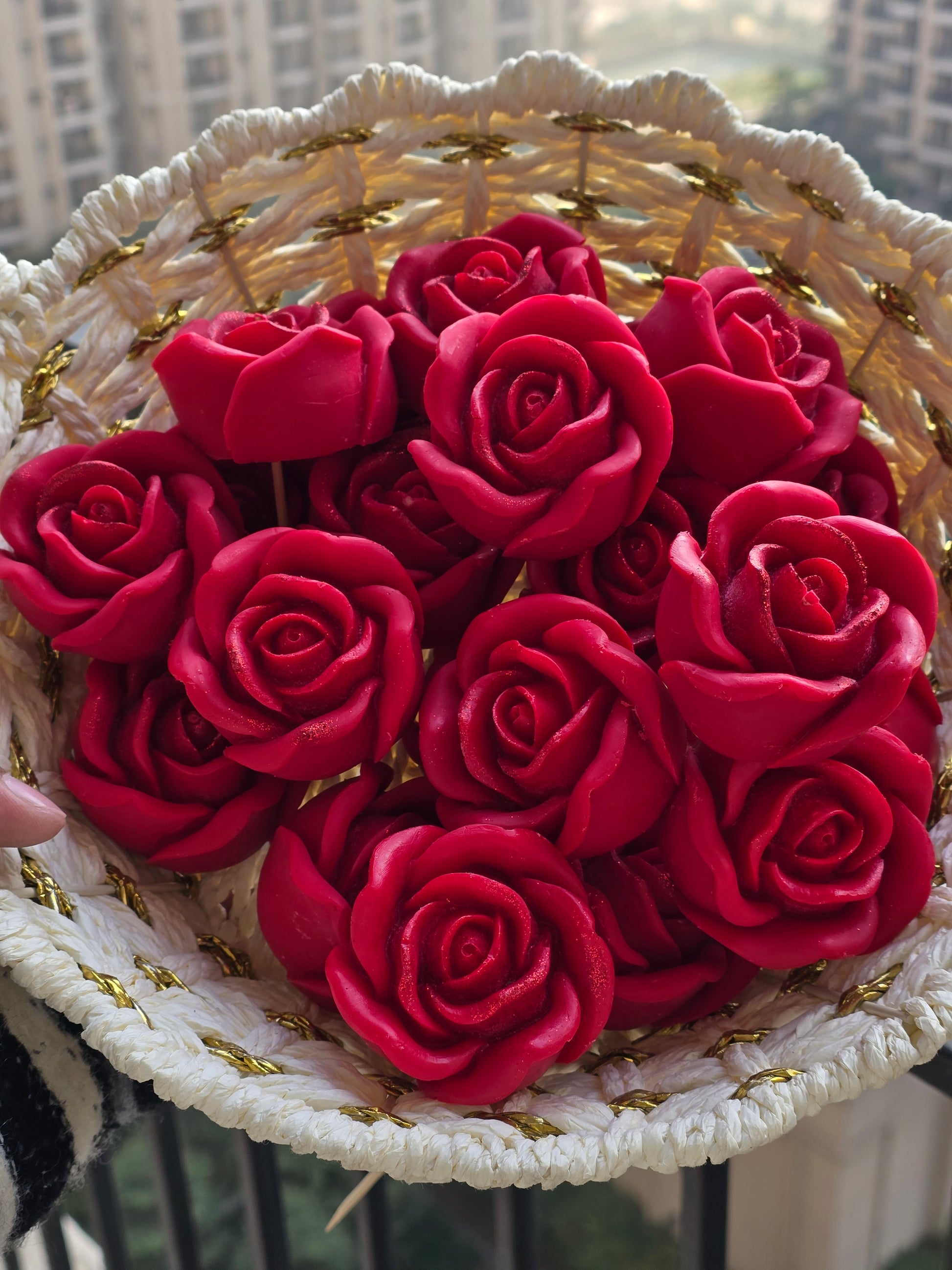 Handwoven basket filled with red floral soy wax candles by Fiorance Luxe