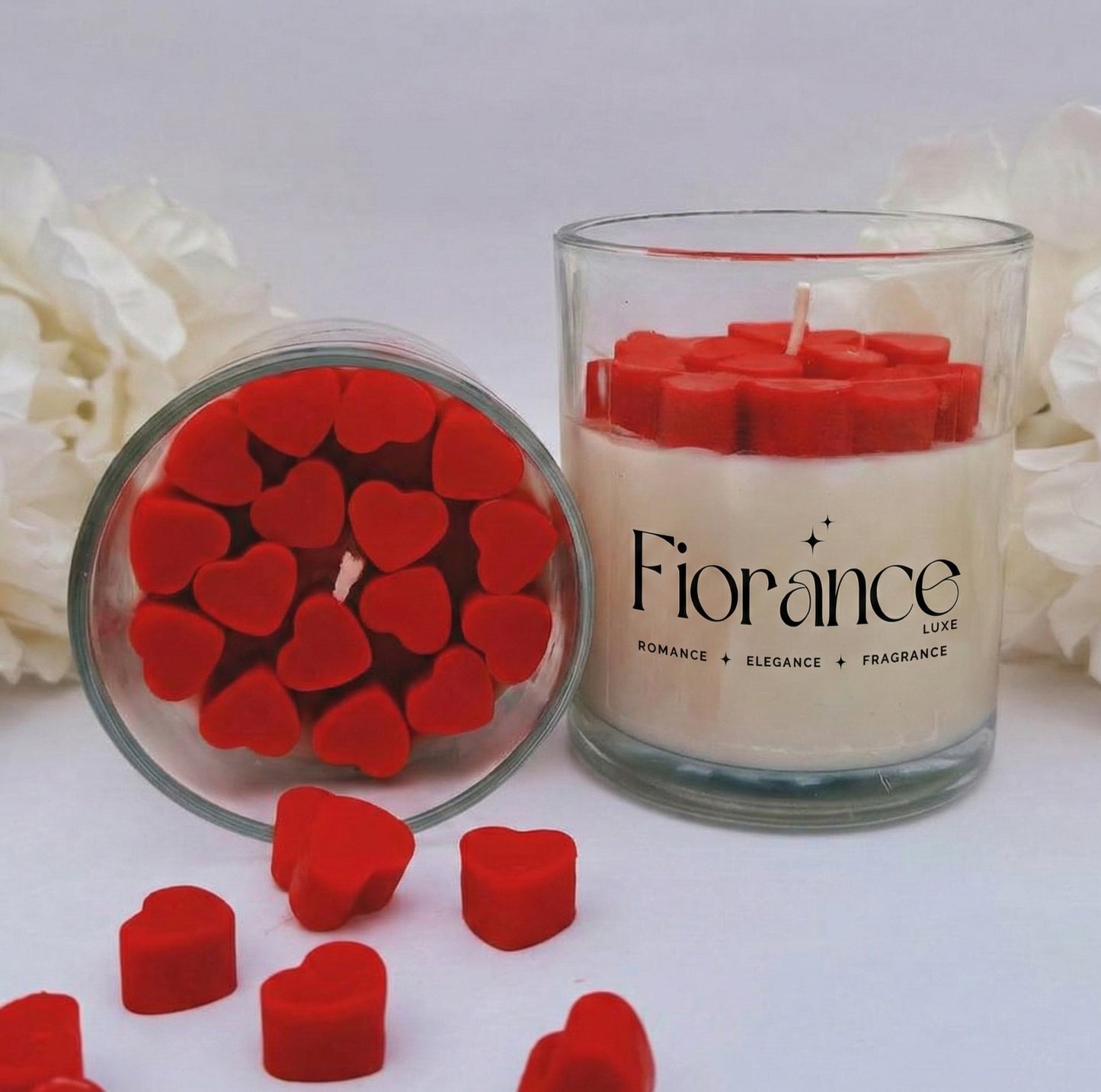 Fiorance Luxe soy wax candle in glass jar with red heart-shaped wax pieces, floral decor