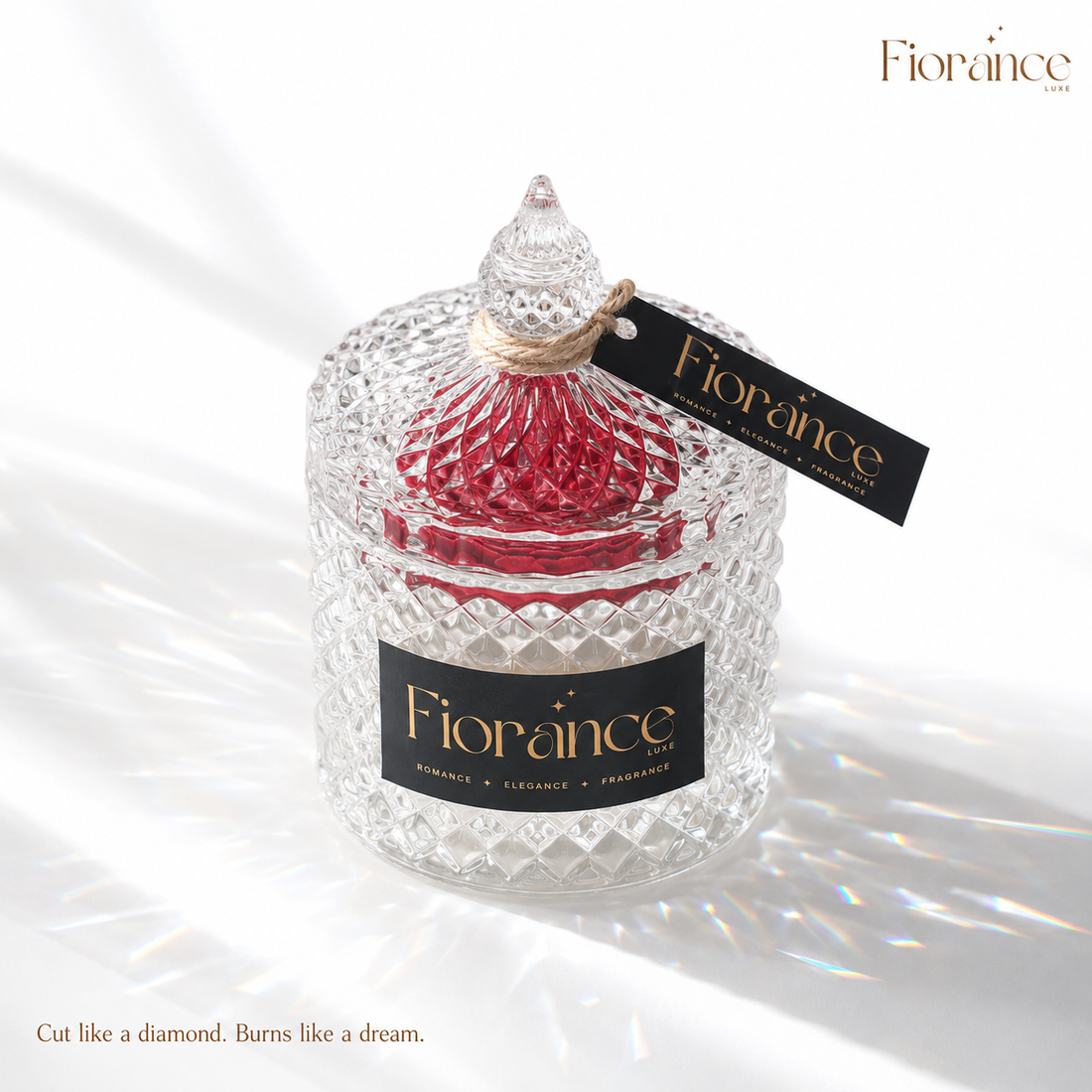 Decorative candle in a diamont cut crystal glass jar with red interior, branded 'Fiorance', on a white background.