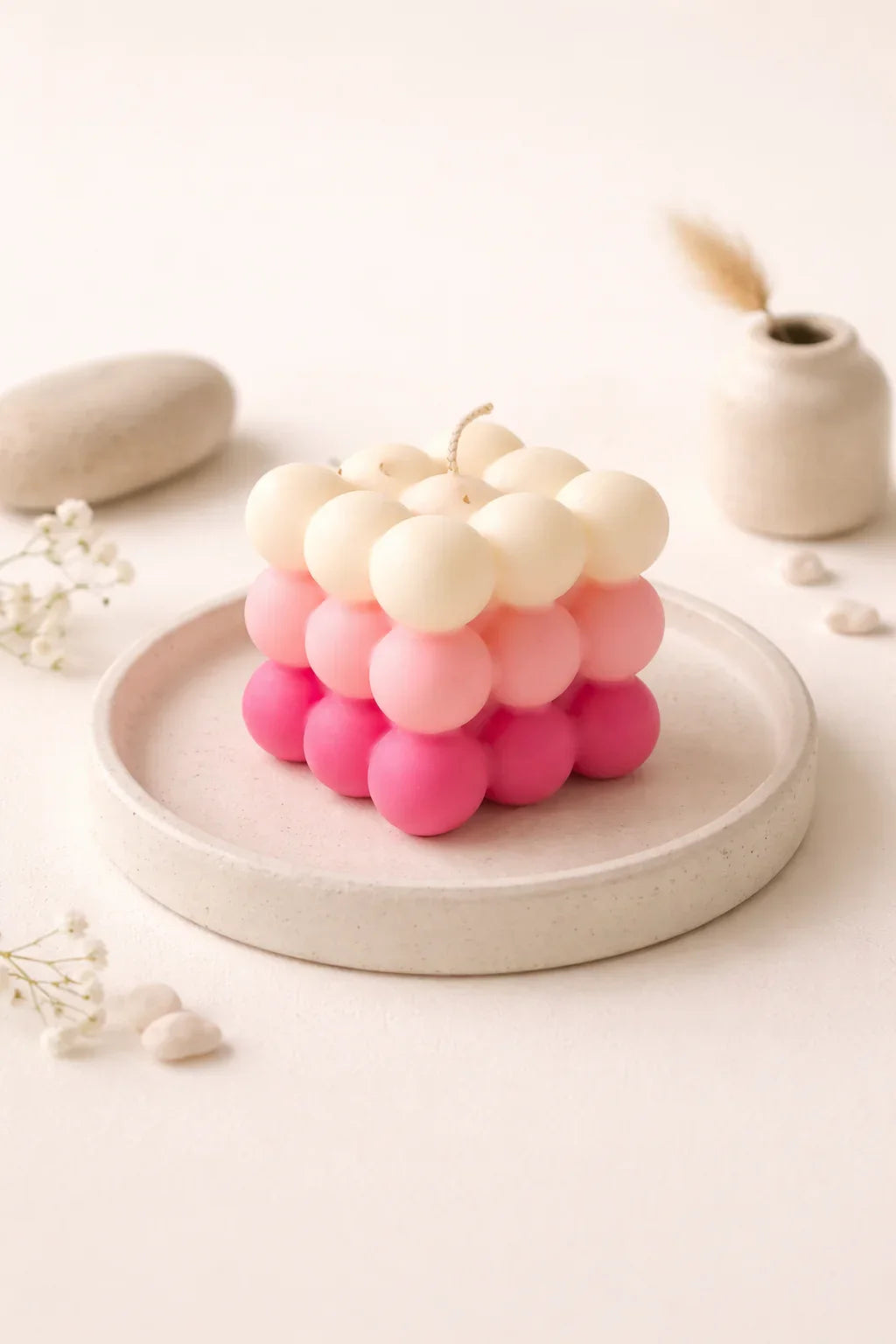 Bubble cube pink and cream soy wax candle by Fiorance Luxe on ceramic plate, elegant decor