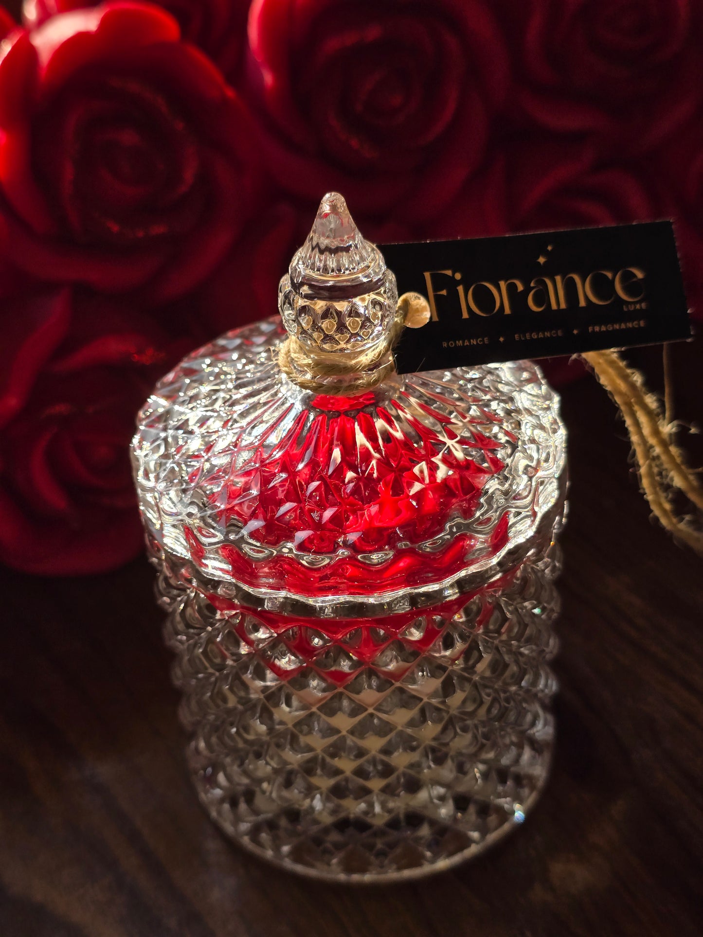 Fiorance Luxe luxury soy wax candle in an elegant glass jar with red roses background