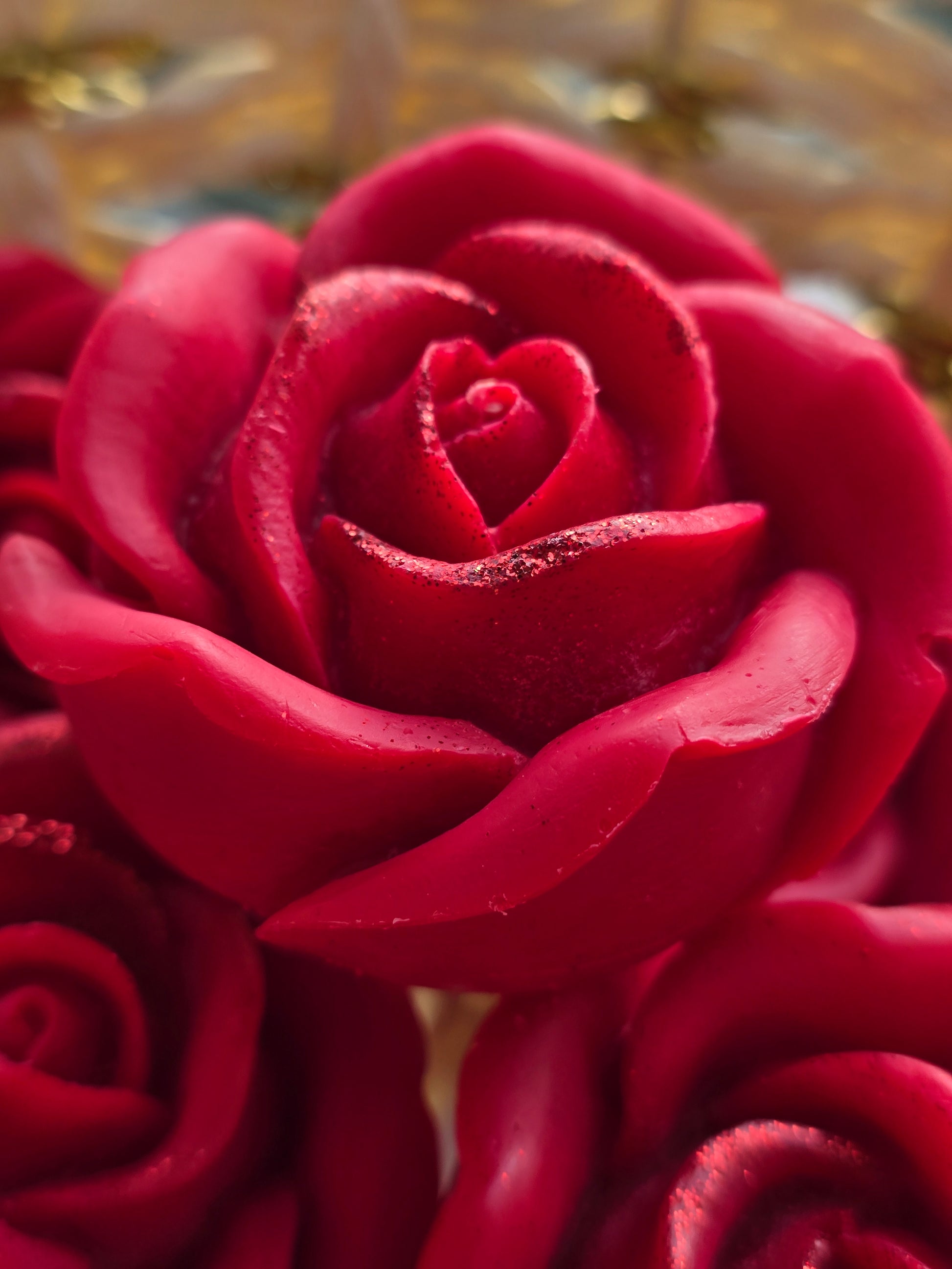 Close-up of a handcrafted red rose soy wax candle by Fiorance Luxe, India