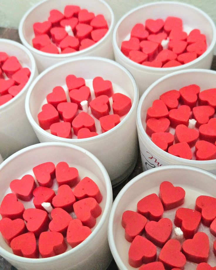 Fiorance Luxe soy wax candles with red heart-shaped decorations in white jars
