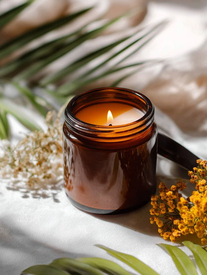 Luxury soy wax candle in amber jar with floral decor on white cloth, Fiorance Luxe
