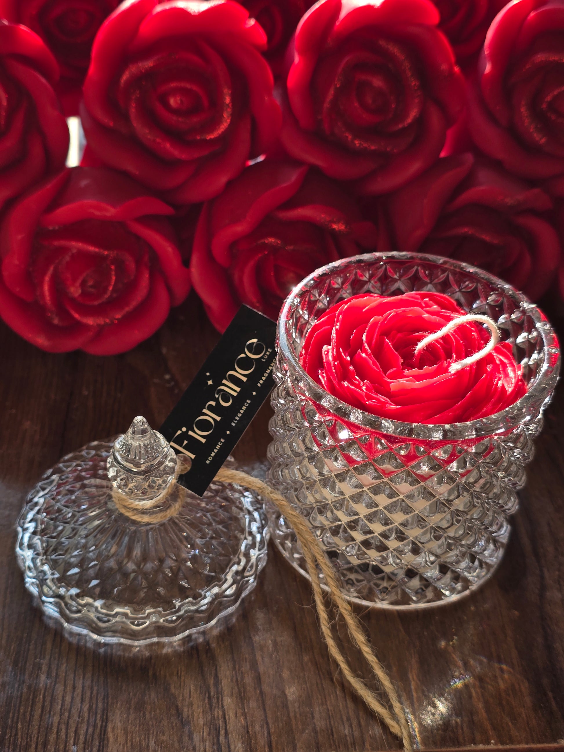 Fiorance Luxe floral soy wax rose candle in crystal jar with red roses background, luxury décor